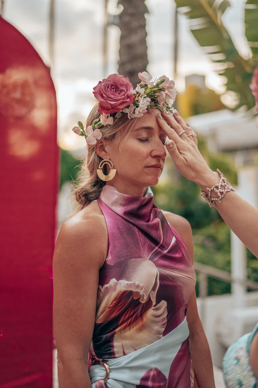 A Starseed Summit guest in a rose crown receiving a blessing at the 2026 VIP dinner